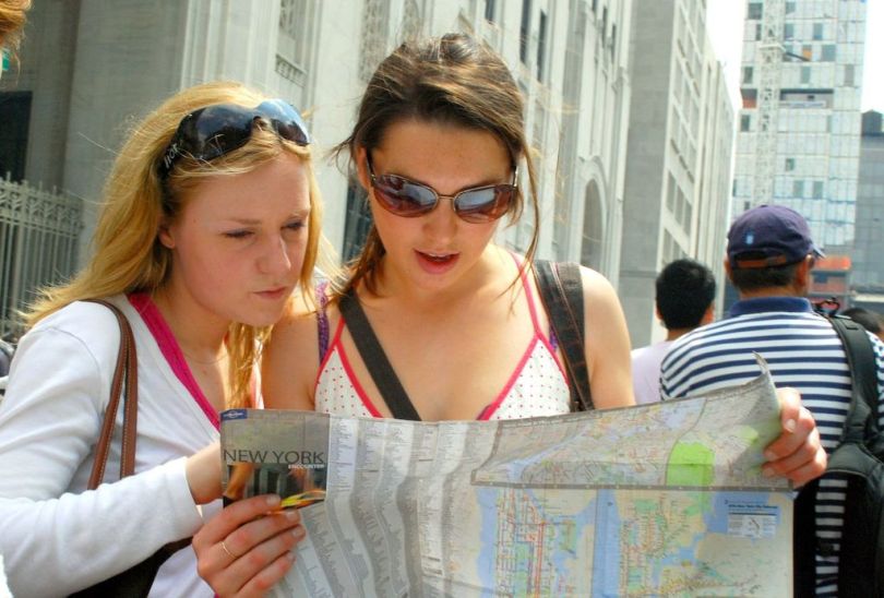 1024px-Two_girls_reading_map_of_NYC